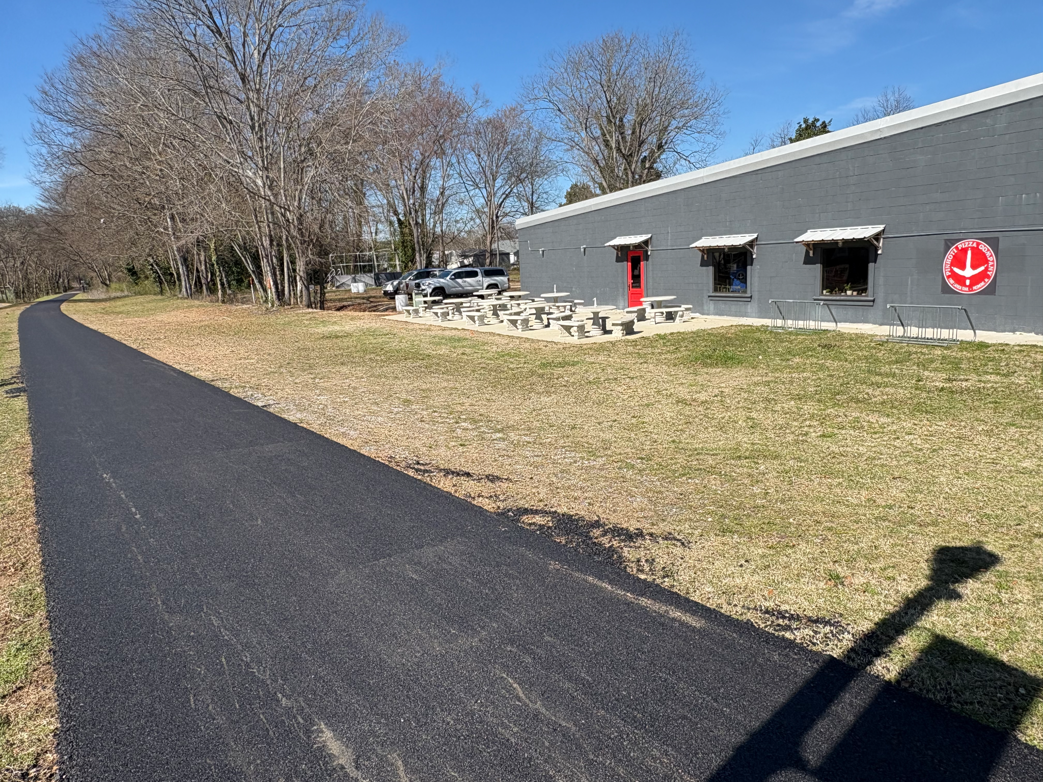 Pinhoti Pizza Company building and outdoor tables directly beside the Chief Ladiga Trail.